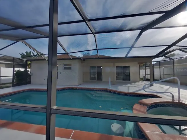 a view of a patio with table and chairs potted plants with wooden floor
