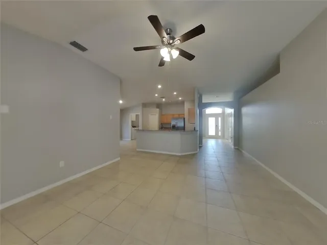 a view of a livingroom with a ceiling fan and window