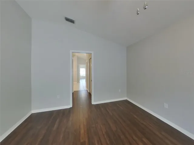 a view of an empty room and wooden floor