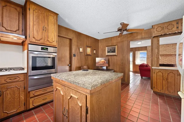 a kitchen with stainless steel appliances granite countertop a stove and a microwave