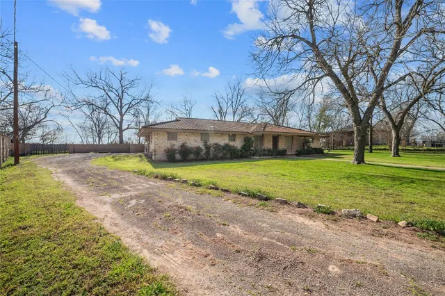 a view of a house with yard and a garden