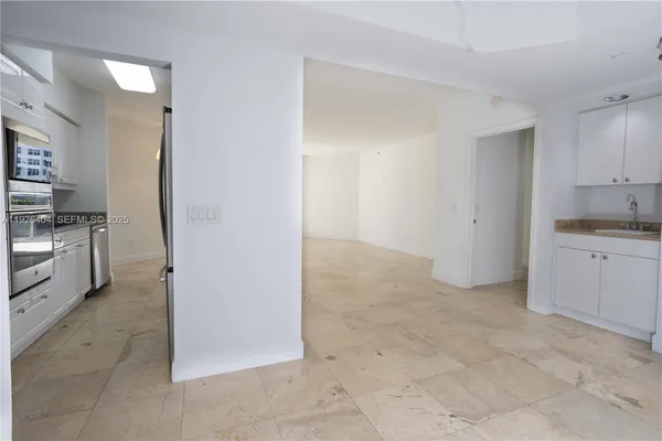 a view of a kitchen with white cabinets
