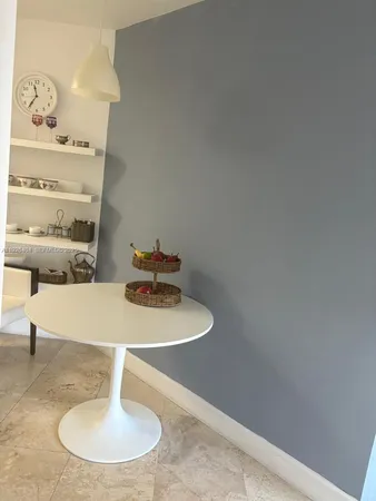 a close view of dining table with chairs