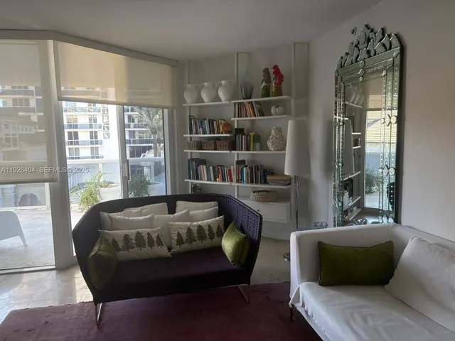 a living room with furniture and a floor to ceiling window
