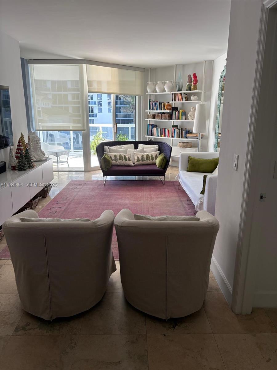 4779 Collins Avenue, Unit 504 Miami Beach, FL 33140 - Photo 18 of 45 a living room with furniture and a window