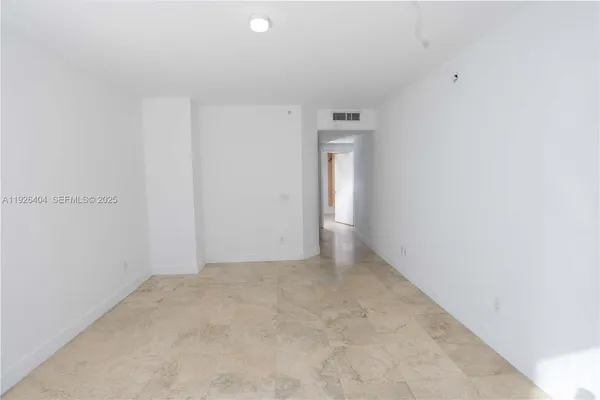 a bedroom with a bed and glass window