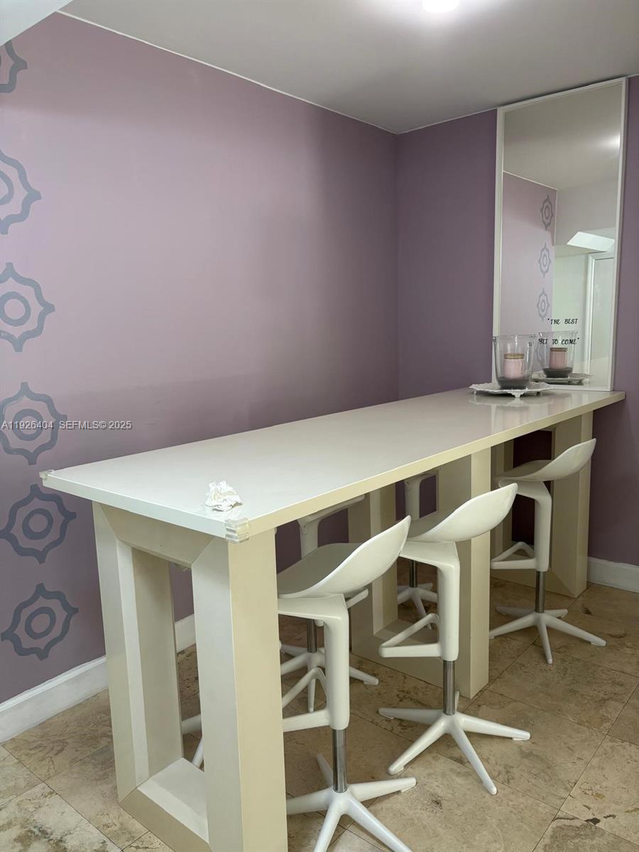 4779 Collins Avenue, Unit 504 Miami Beach, FL 33140 - Photo 26 of 45 a view of a room with table chairs and wooden floor