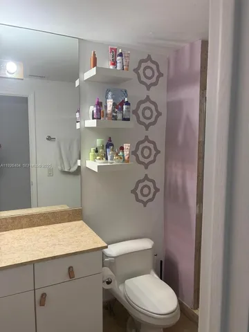a bathroom with a tub a double vanity sink and a large mirror