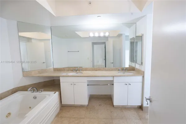 a bathroom with a granite countertop sink toilet and a mirror