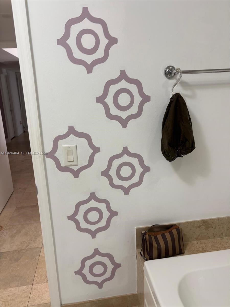 4779 Collins Avenue, Unit 504 Miami Beach, FL 33140 - Photo 32 of 45 a bathroom with a sink and a mirror