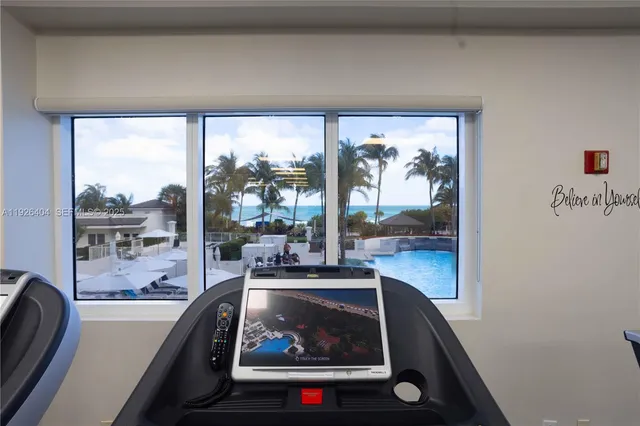 a view of a patio with furniture and umbrella