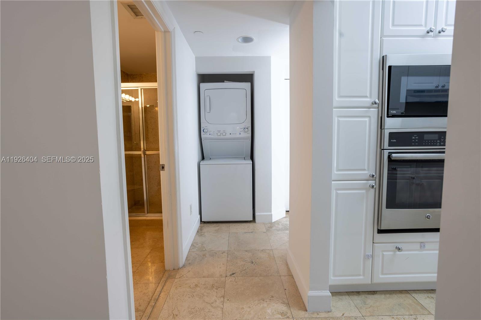 4779 Collins Avenue, Unit 504 Miami Beach, FL 33140 - Photo 10 of 45 a view of a kitchen from the hallway
