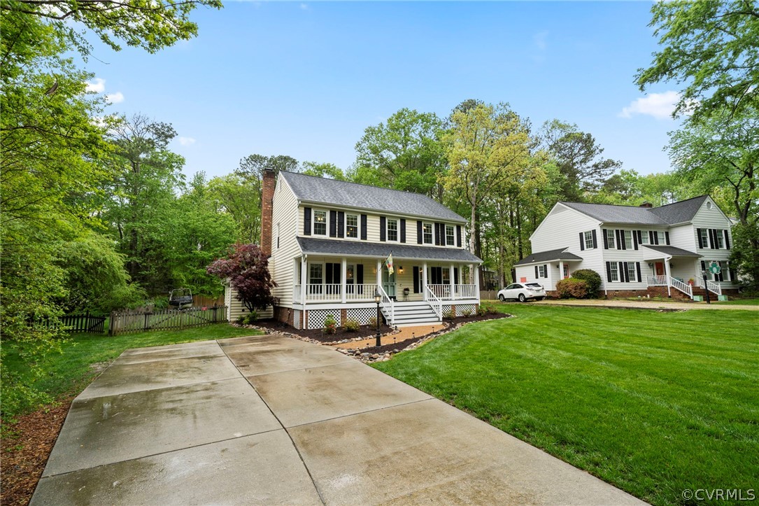 12516 Cutler Ridge Drive Henrico, VA 23233 - Photo 2 of 34 a view of a white house in front of a yard with plants and large trees