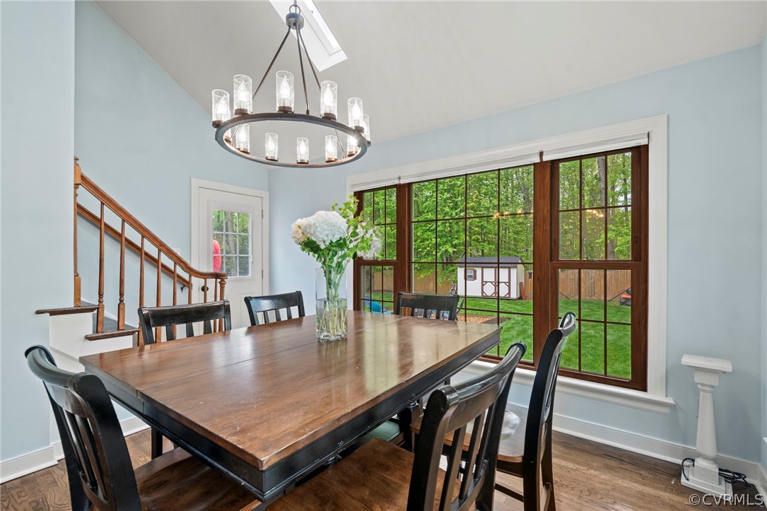 12516 Cutler Ridge Drive Henrico, VA 23233 - Photo 21 of 34 a dining room with wooden floor a chandelier a wooden table and chairs