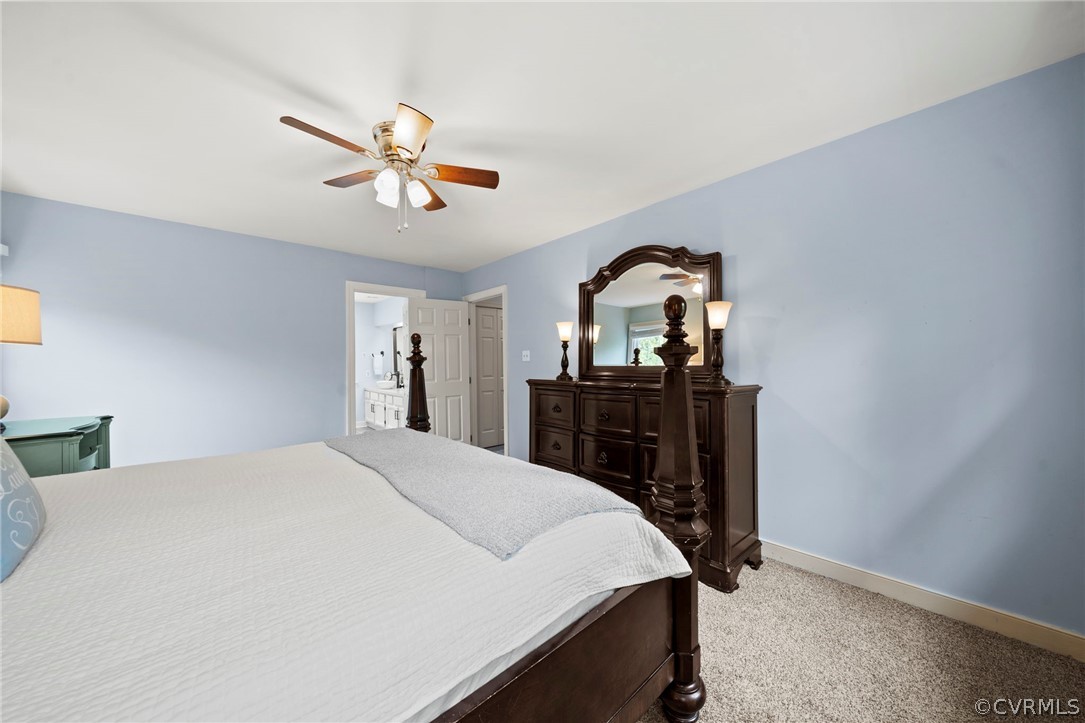 12516 Cutler Ridge Drive Henrico, VA 23233 - Photo 24 of 34 a bedroom with a bed and a chandelier