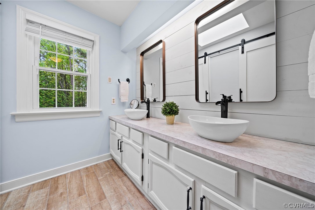 12516 Cutler Ridge Drive Henrico, VA 23233 - Photo 25 of 34 a bathroom with a double vanity sink and a mirror