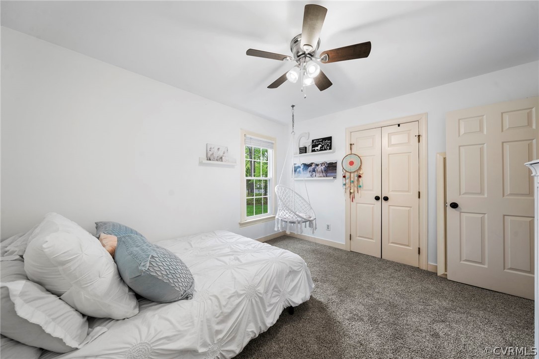 12516 Cutler Ridge Drive Henrico, VA 23233 - Photo 27 of 34 a spacious bedroom with a bed and a chandelier