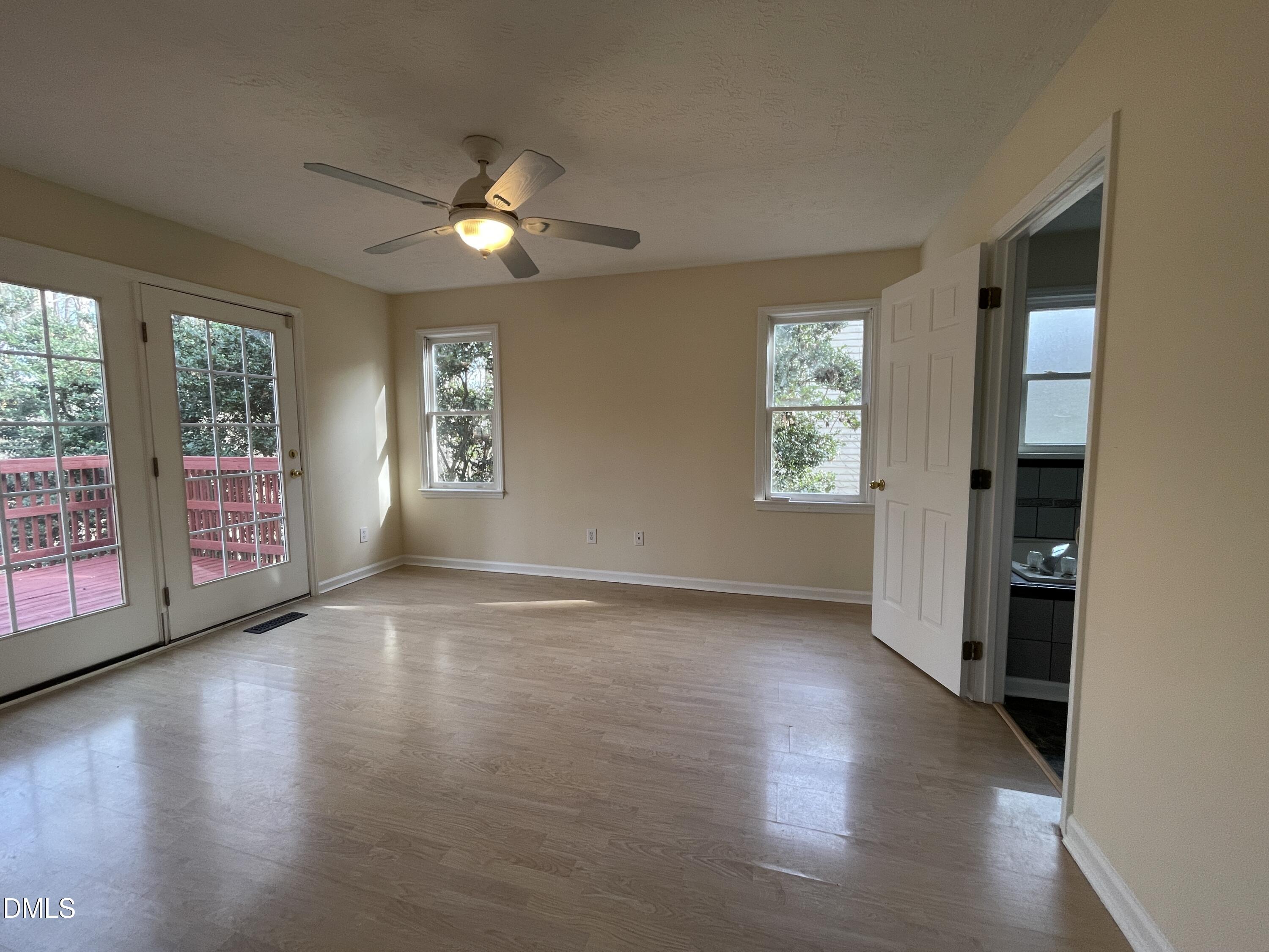 5632 Millrace Trail Raleigh, NC 27606 - Photo 12 of 26 a view of an empty room with a window and wooden floor