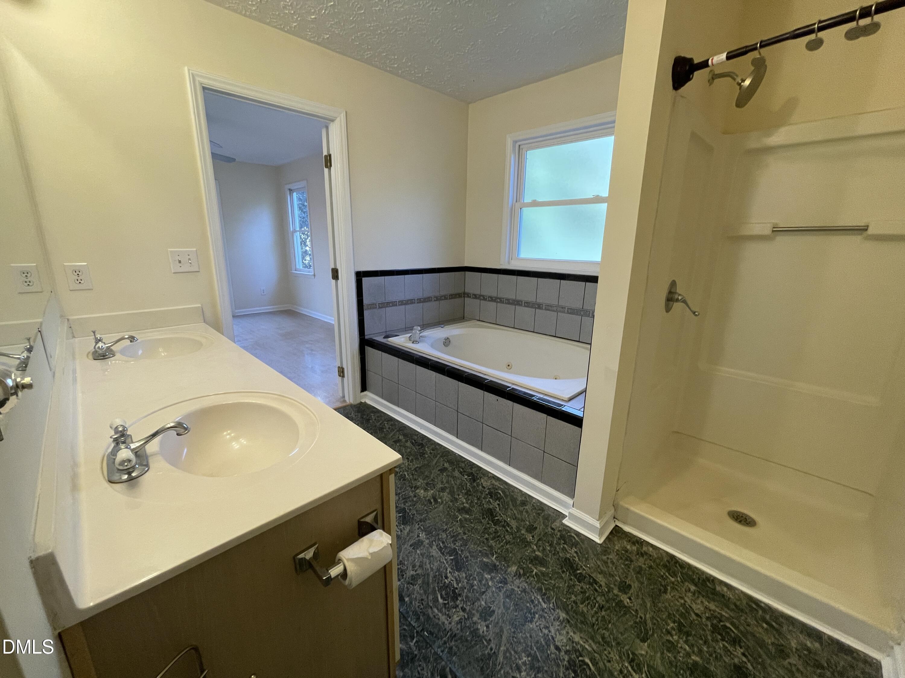5632 Millrace Trail Raleigh, NC 27606 - Photo 15 of 26 a bathroom with a sink a mirror and shower