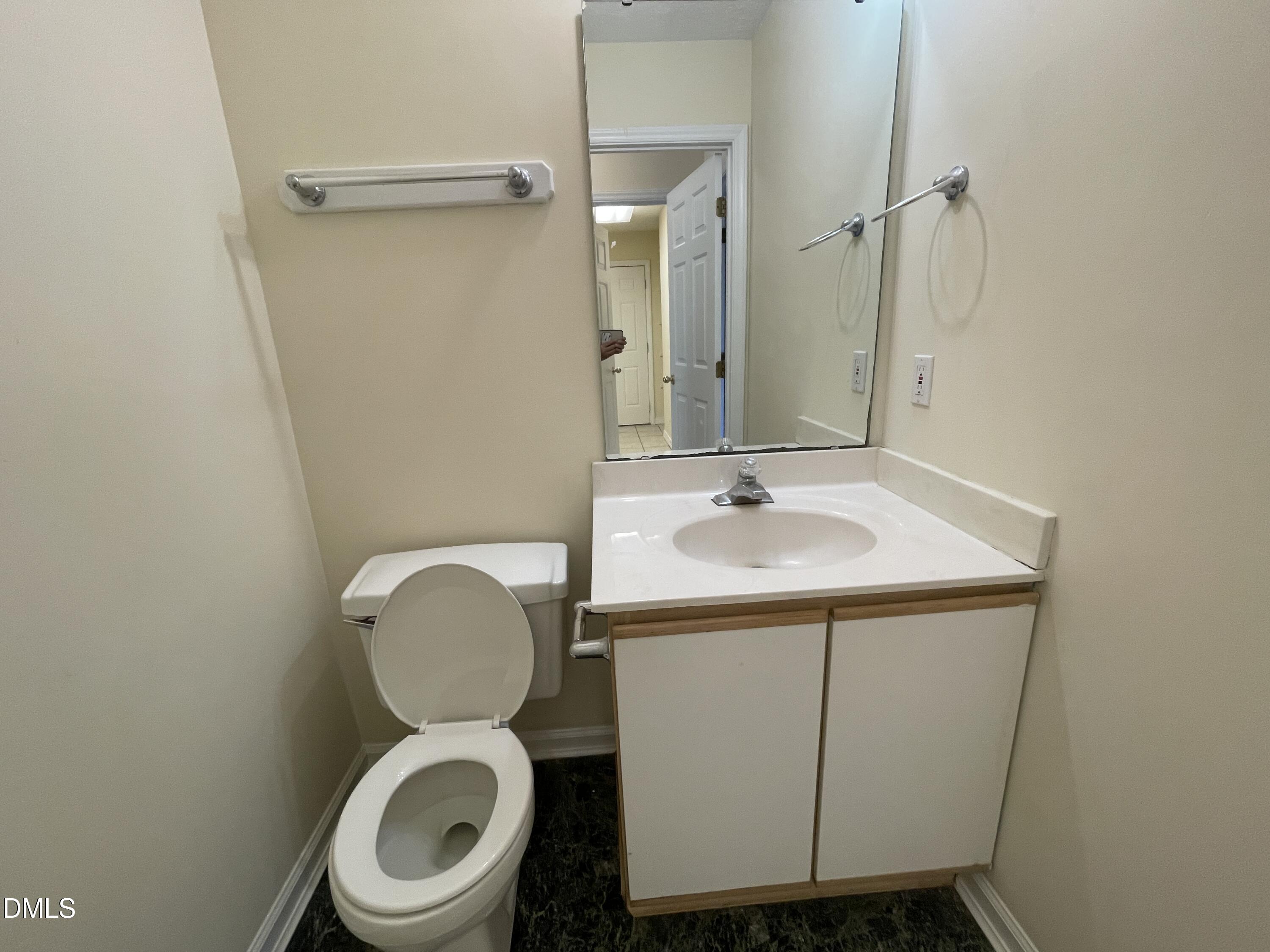 5632 Millrace Trail Raleigh, NC 27606 - Photo 16 of 26 a bathroom with a toilet sink and a mirror