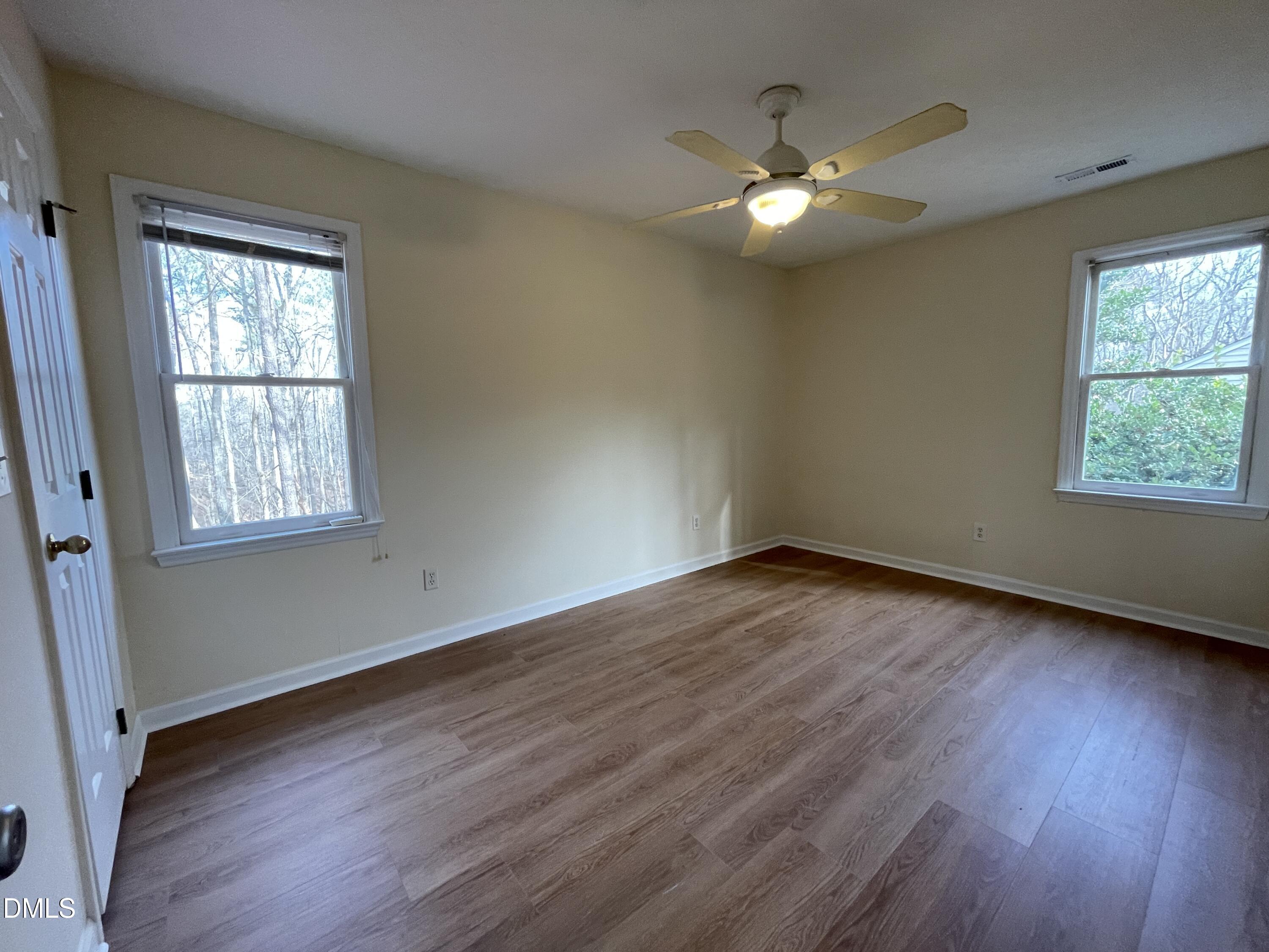 5632 Millrace Trail Raleigh, NC 27606 - Photo 18 of 26 a view of an empty room with wooden floor and a window