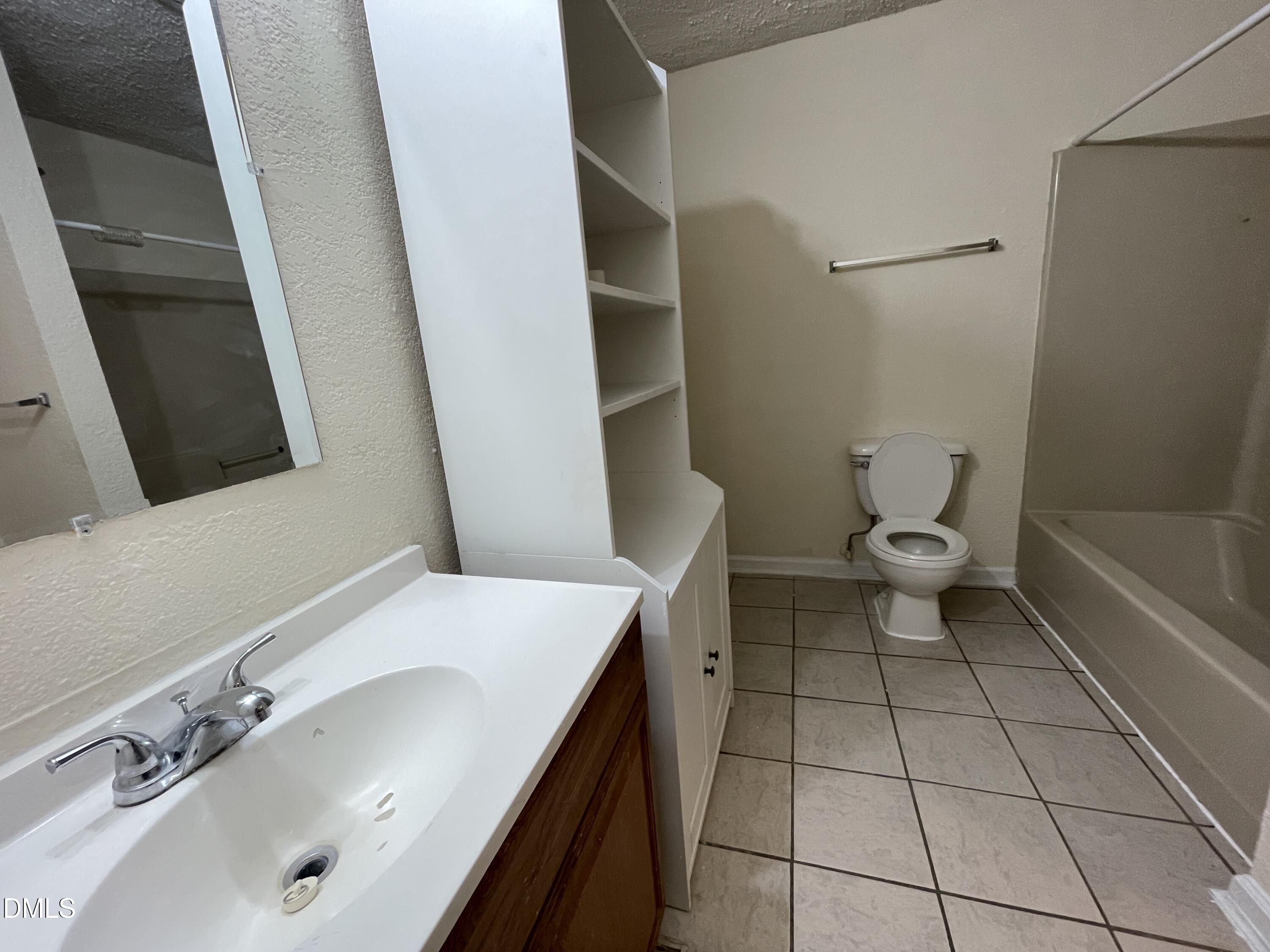 5632 Millrace Trail Raleigh, NC 27606 - Photo 24 of 26 a bathroom with a sink a toilet and shower