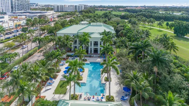 an aerial view of a house with a yard and lake view