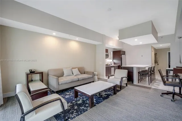 a living room with furniture a wooden floor and a rug