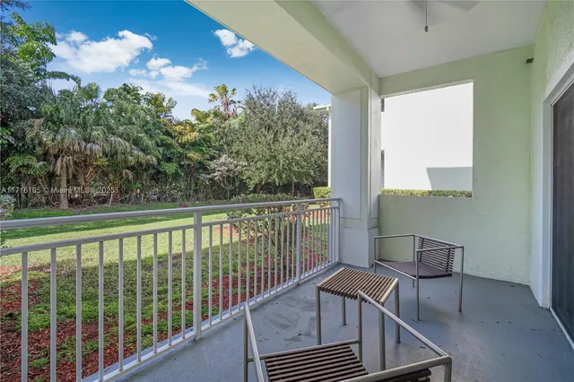 a view of a balcony with furniture