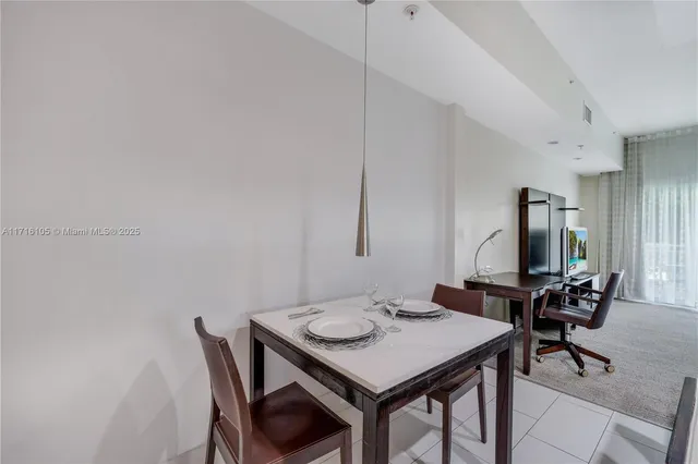 a view of a dining room with furniture and window