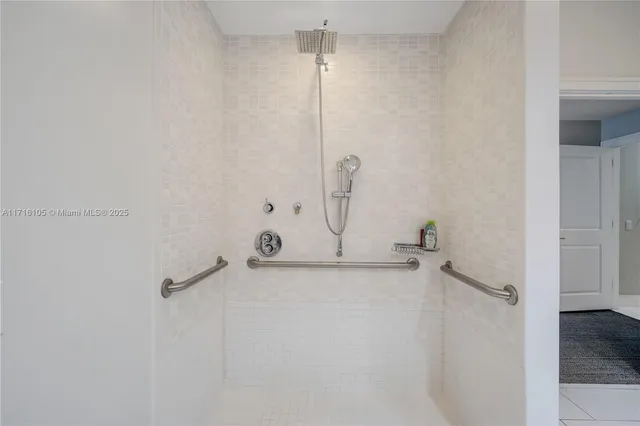 a bathroom with a tub a sink and mirror