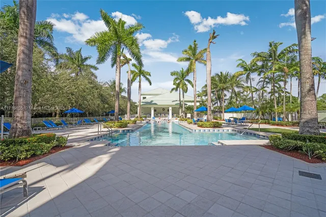 a view of yard with swimming pool and sitting area