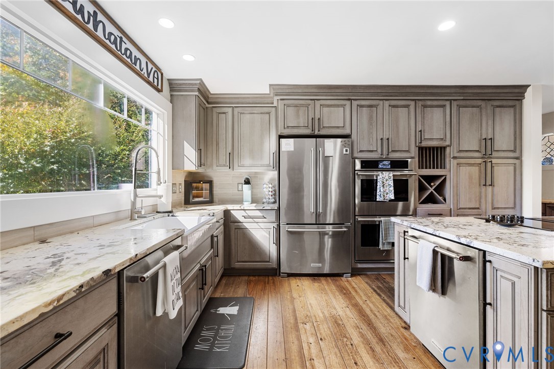 6256 Old Buckingham Road Powhatan, VA 23139 - Photo 13 of 48 a kitchen with a white cabinets and wooden floor