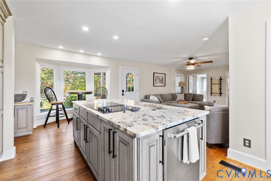 6256 Old Buckingham Road Powhatan, VA 23139 - Photo 16 of 48 a kitchen with a stove a sink a refrigerator and wooden floor