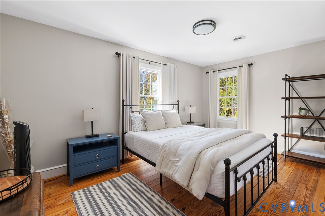 6256 Old Buckingham Road Powhatan, VA 23139 - Photo 28 of 48 a bedroom with a bed and a flat tv screen on dresser