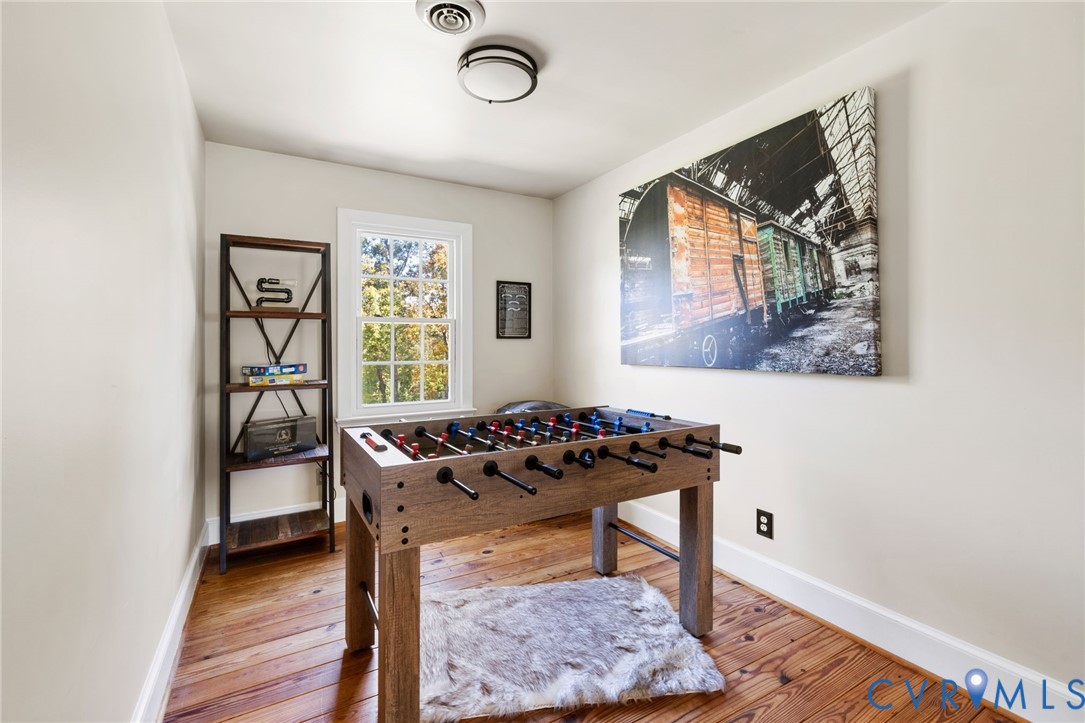 6256 Old Buckingham Road Powhatan, VA 23139 - Photo 32 of 48 a table and chair in a room with wooden floor