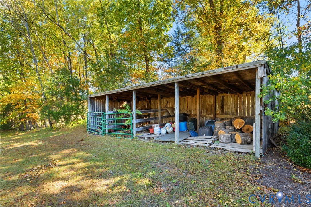 6256 Old Buckingham Road Powhatan, VA 23139 - Photo 41 of 48 a view of a backyard with table and chairs and a large tree