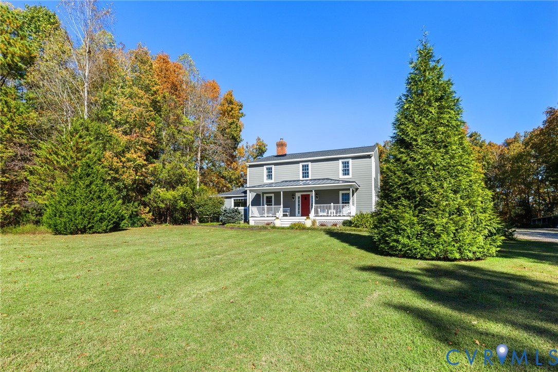 6256 Old Buckingham Road Powhatan, VA 23139 - Photo 44 of 48 a front view of a house with a garden
