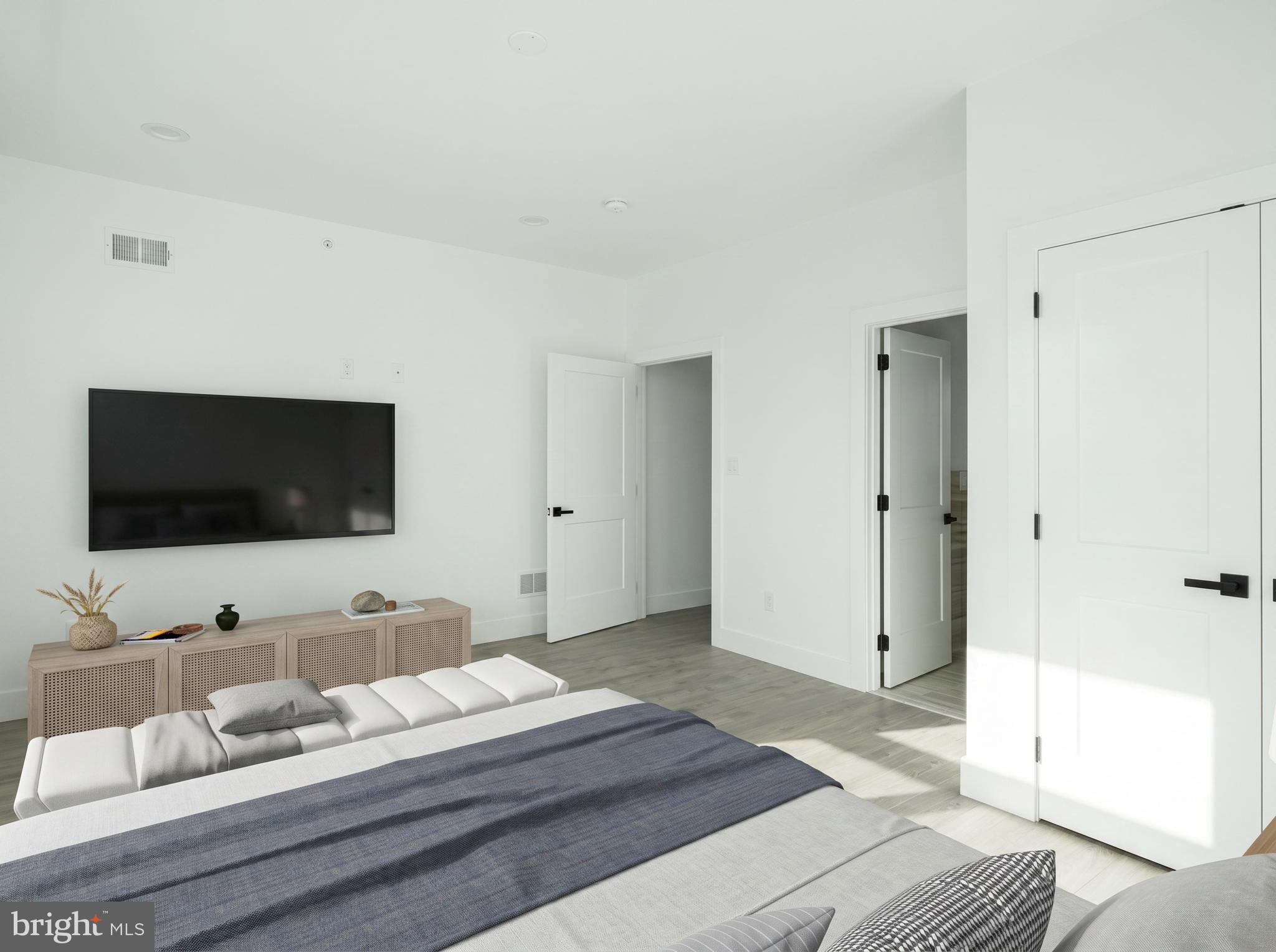 2827 Edgemont Street Philadelphia, PA 19134 - Photo 13 of 25 a bedroom with a bed and a flat screen tv