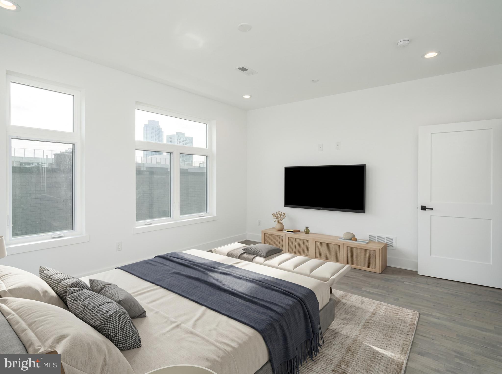 2827 Edgemont Street Philadelphia, PA 19134 - Photo 14 of 25 a bedroom with a bed and a flat screen tv
