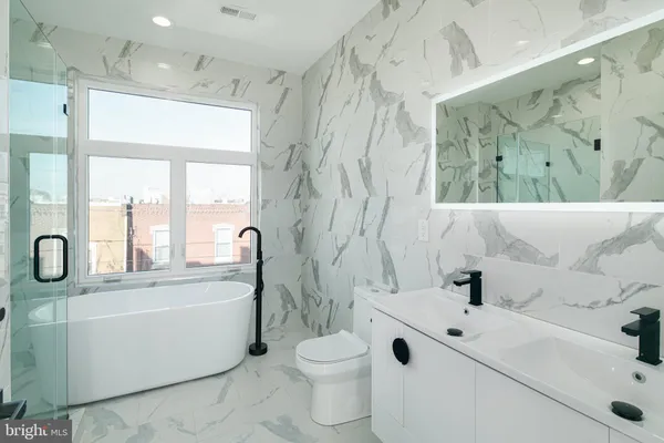 a bathroom with a sink a toilet and a tub