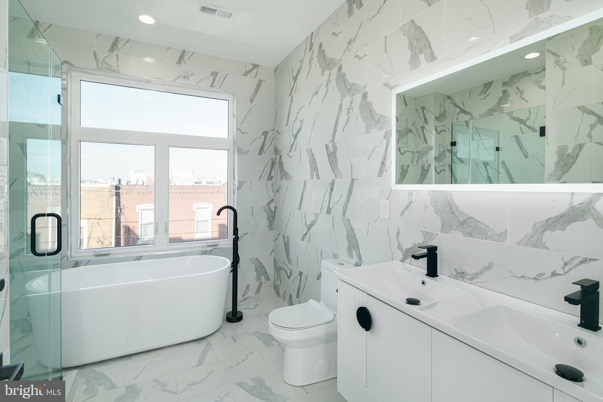 2827 Edgemont Street Philadelphia, PA 19134 - Photo 16 of 25 a bathroom with a sink a toilet and a tub