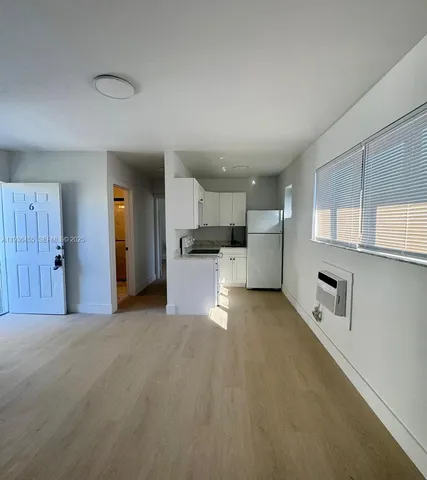a view of a kitchen with a sink and cabinets