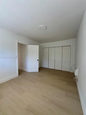 a view of an empty room and closet area