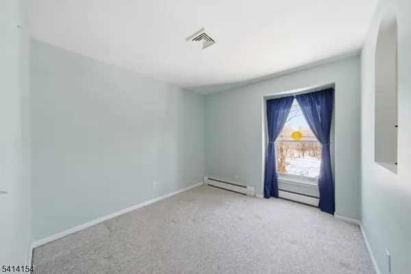 a kitchen with granite countertop a sink cabinets stainless steel appliances and a window