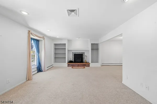 a kitchen with refrigerator and cabinets