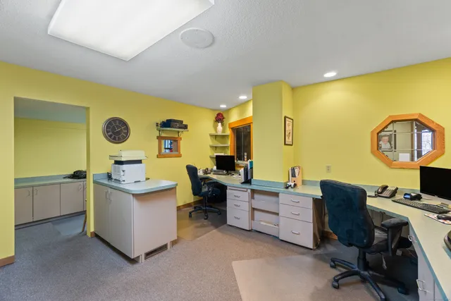 a view of a kitchen with fridge and workspace
