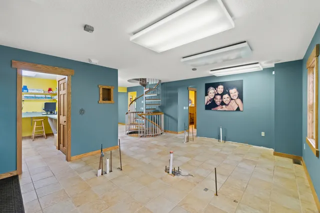 a view of a kitchen with furniture and a refrigerator