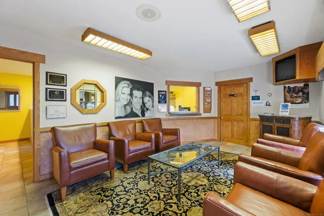 a view of a living room with furniture and wooden floor