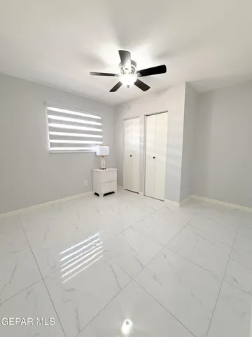 a view of a livingroom with a ceiling fan and window